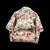 Fauteuil miniature en tissu fleuri et bois, idéal pour une maison de poupée élégante. Modèle 