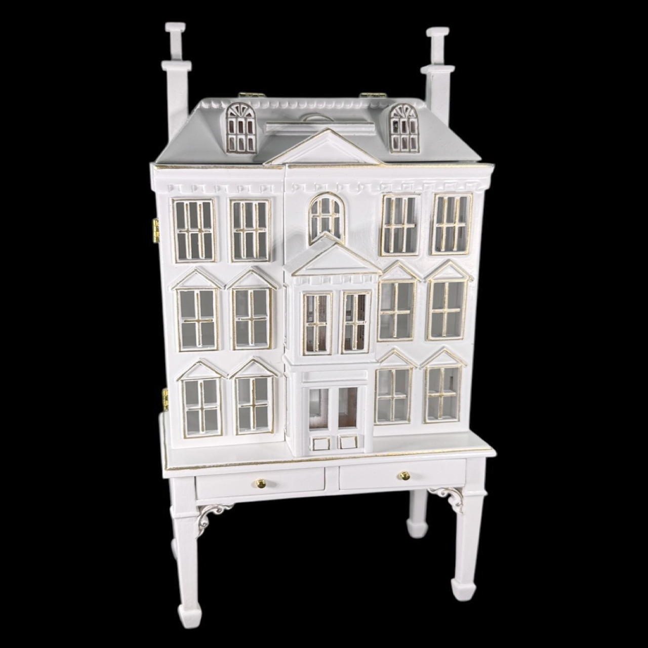Maison miniature ouvrante avec table et tiroirs, parfaite pour une maison de poupée élégante. Finition blanche avec filets dorés, idéale pour ranger de petits accessoires.Vue principale