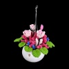 Suspension florale miniature multicolore avec pot blanc en céramique sur fond noir