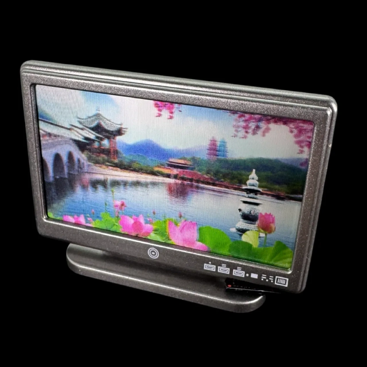 Téléviseur écran plat avec télécommande sur fond noir 1/12e