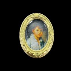 Tableau miniature ovale doré avec portrait d'enfant sur fond noir