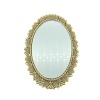 Miroir miniature ovale doré à décor floral sur fond blanc