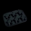 Dos du moule à gâteaux miniature noir avec 6 empreintes en forme d'étoile sur fond noir