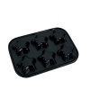 Dos du moule à gâteaux miniature noir avec 6 empreintes en forme d'étoile sur fond blanc